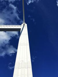 Low angle view of communications tower against cloudy sky