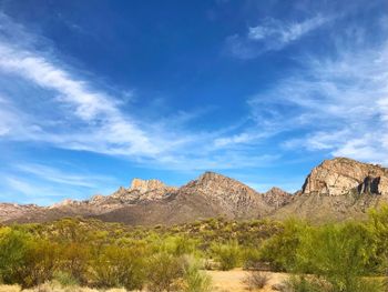 Scenic view of rocky mountains against blue sky