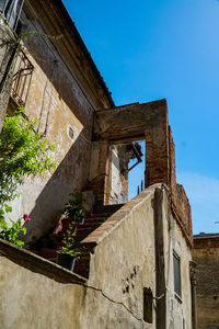 Low angle view of old building against clear blue sky