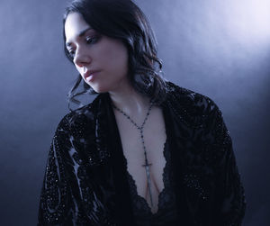 Beautiful young woman looking away over white background