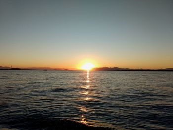 Scenic view of sea against clear sky during sunset