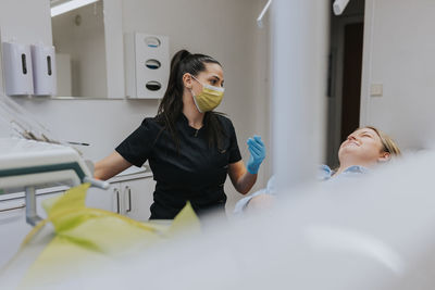 Female dentist with patient in dentist's office