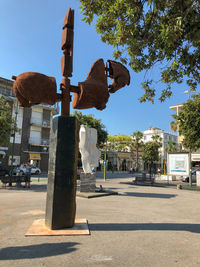 Street by road against sky in city