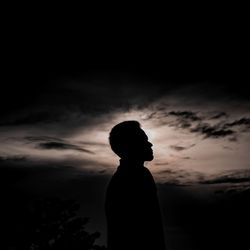 Silhouette woman standing against sky during sunset