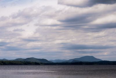 Scenic view of land and mountains against sky