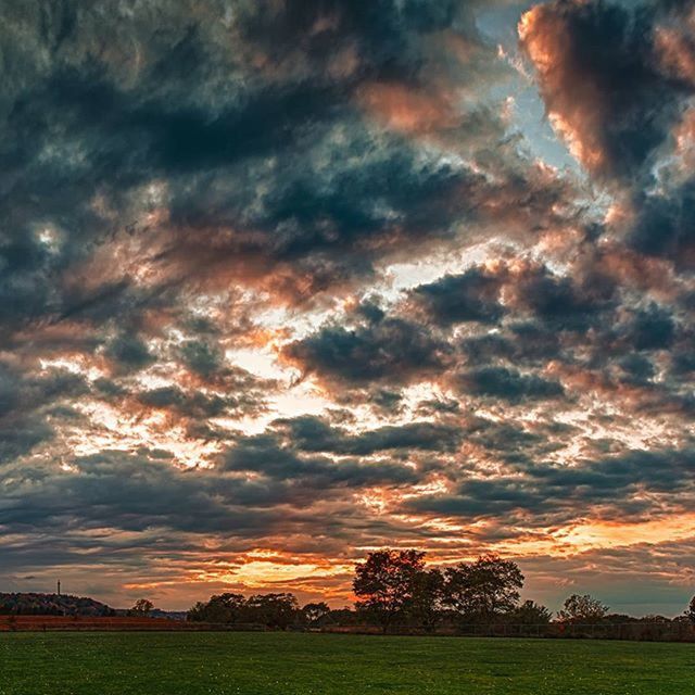 sky, cloud - sky, sunset, tranquil scene, tranquility, landscape, cloudy, scenics, beauty in nature, field, dramatic sky, nature, cloud, grass, tree, idyllic, overcast, weather, moody sky, orange color