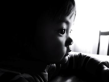 Profile view of girl looking away at home