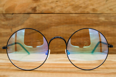 Close-up of sunglasses on wood