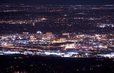 High angle view of illuminated buildings in city at night