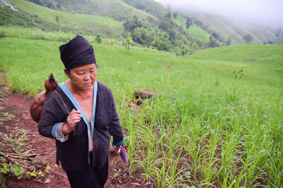 Young woman standing on field