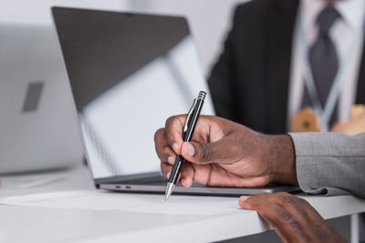 Midsection of man working on table