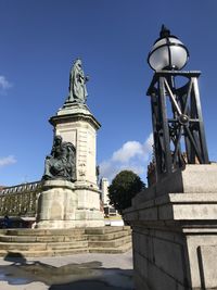Low angle view of statue against sky