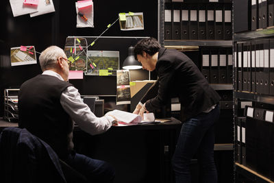 Side view of colleagues working at home