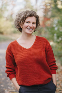 Portrait of smiling young woman standing outdoors