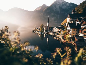 Town by river against mountains