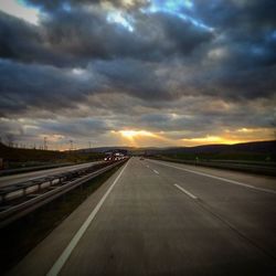 Dramatic sky over road at sunset