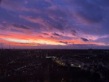 High angle view of illuminated cityscape against sky during sunset