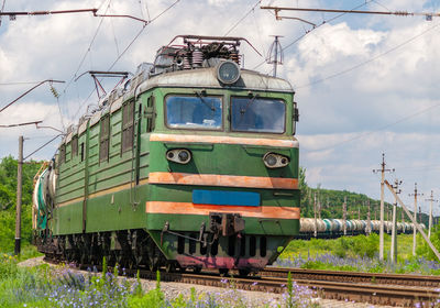 Train on railroad track against sky