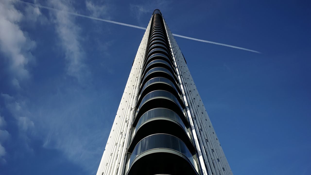 sky, low angle view, architecture, blue, built structure, cloud - sky, no people, nature, day, building exterior, outdoors, building, tall - high, vapor trail, pattern, sunlight, tower, belief, religion, metal, spire, directly below