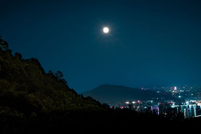 Scenic view of mountains against sky at night