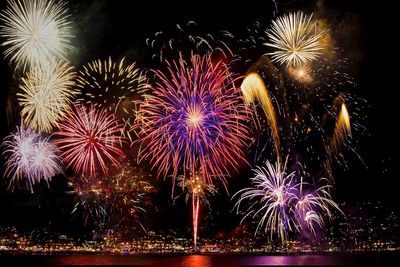 Low angle view of firework display at night