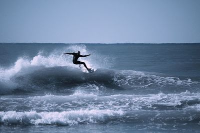 View of a silhouette man surfing in the sea