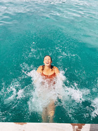 Portrait of smiling woman swimming in pool