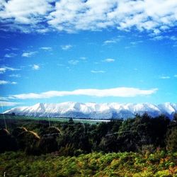 Scenic view of mountains against cloudy sky