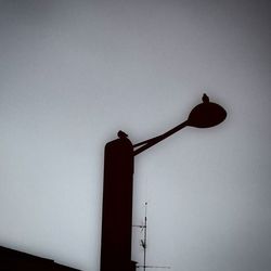 Low angle view of street light against clear sky