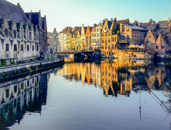 Reflection of buildings in city against sky