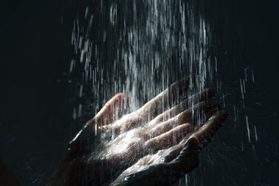 Close-up of water falling on hands