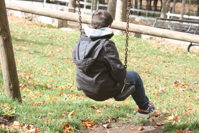 Rear view of boy on field