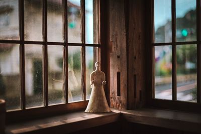 Angel figurine on window sill at home