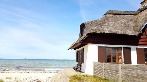 House by sea against sky