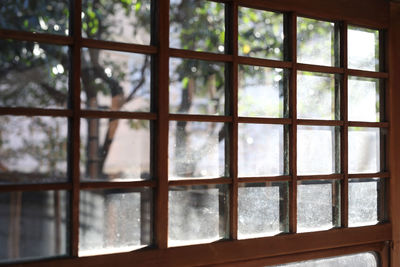 Close-up of window with brown frame