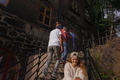 Low angle view of friends on steps