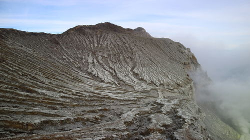 Scenic view of volcanic mountain against sky