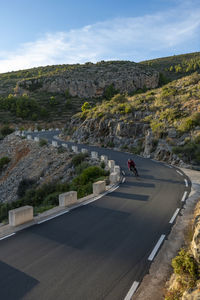 Road by mountain against sky