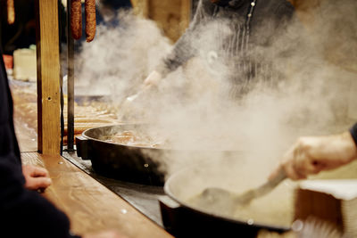 Process of cooking street food outdoors. frying pan with fried dishes