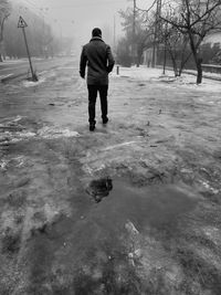 Full length of man in puddle