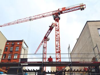 Low angle view of crane against sky