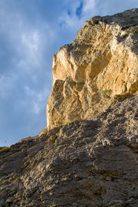 Low angle view of rock formations against sky