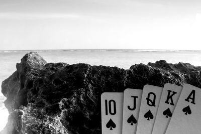 Close-up of rock formation on beach against sky
