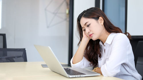 Young woman using laptop at home