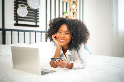Portrait of young woman using phone
