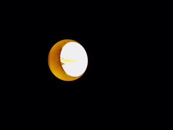 Low angle view of illuminated lamp against clear sky at night