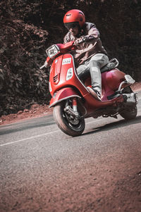 Man riding motorcycle on road