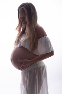 Woman standing against white background