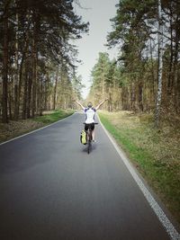 People riding bicycle on road