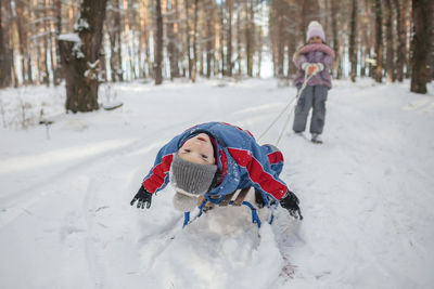 Full length of child in snow on field